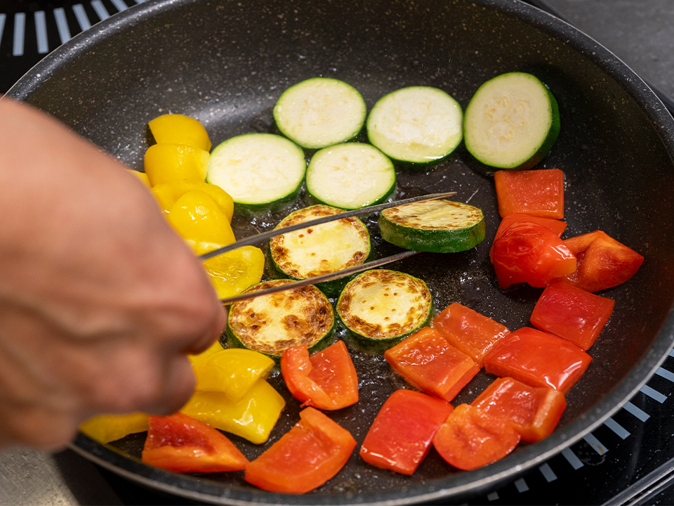 夏野菜をフライパンで焼いている